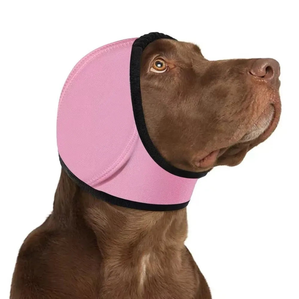 Pink SnoozyPups ear muffs on a brown dog